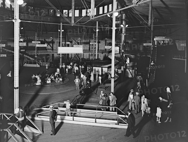 People enjoying a fund day at an emusement park (fun house and spinning wheel) in Glen Echo, Md. ca.  between 1910 and 1935 (probably 1928)