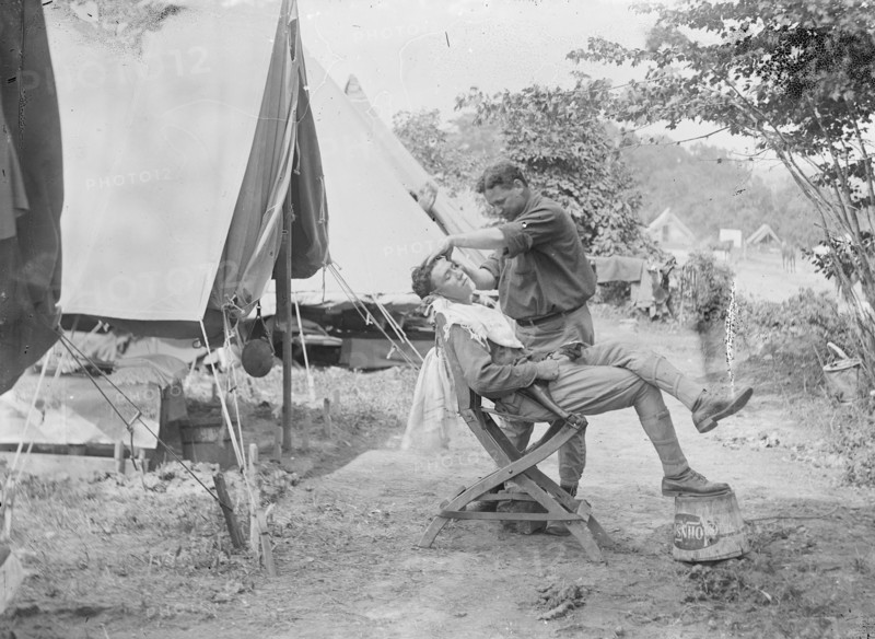 Soldier receiving a shave at a U.S. Army or National Guard camp ca. between 1909 and 1940