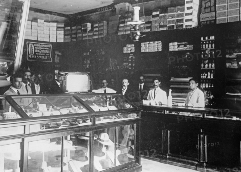 W&R Store of a British importer, workers standing behind a display of hats ca. between 1909 and 1919