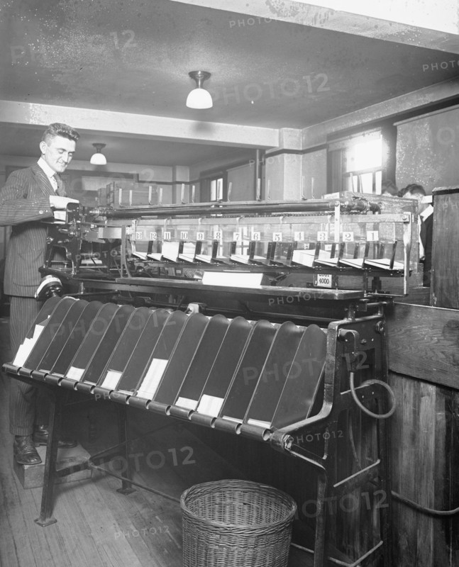 Man working a sorting machine at the U.S. Census Bureau ca. between 1909 and 1940