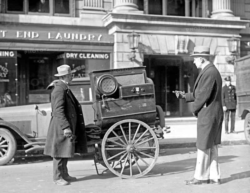 Street scene: men and cart near laundry ca. between 1909 and 1932