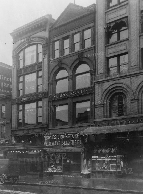 Exterior of People's Drug Store, 11th and G Streets, Washington, D.C., with other shops ca. between 1909 and 1932