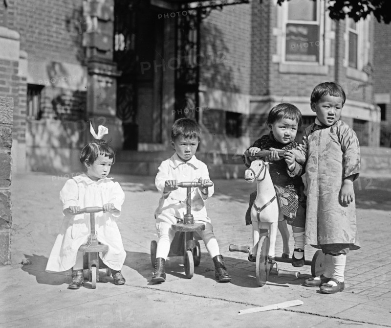 Chinese children playing on tricycles ca.  between 1918 and 1920