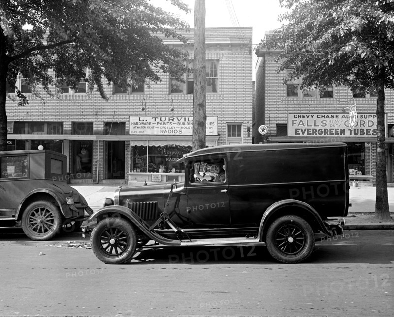 Man driving a delivery truck outside Turville Hardware store, possibly in Chevy Chase Maryland ca.  between 1918 and 1928