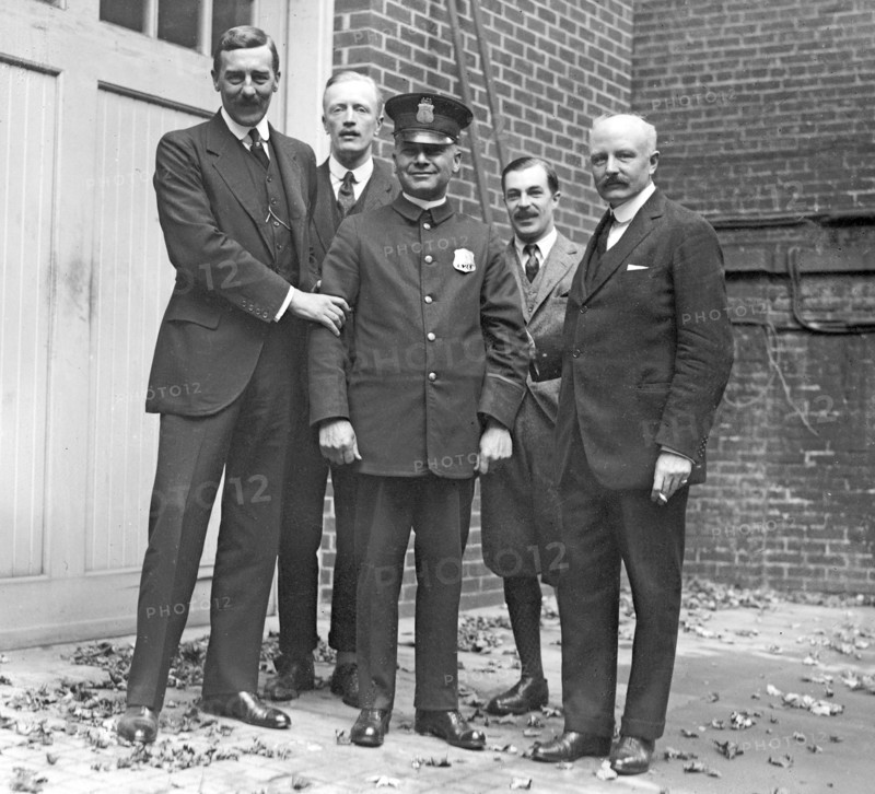 Policeman at the British Embassy, with embassy officials ca.  between 1918 and 1920