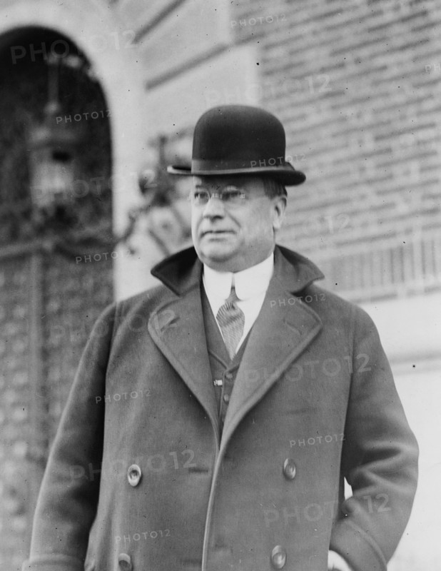 Senator Hiram W. Johnson, half-length portrait, standing, facing left, wearing bowler hat ca. 1909