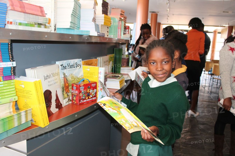 A Namibian school girl looking through a school textbook in a Namibia school ca. 20 July 2017