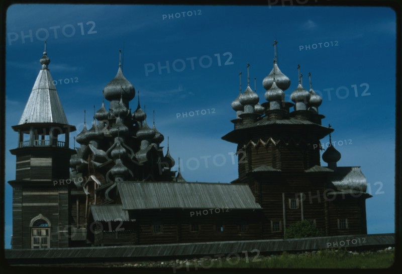 Pogost ensemble, Church of the Intercession (1764), (right); with bell tower (19th century); and Church of the Transfiguration (1714), south view, Kizhi Island, Russia; 1993