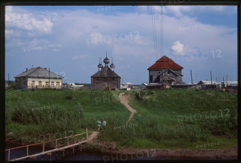 Izhma village, with Izhma River, Church of the Transfiguration, and Church of Resurrection (1887), west panorama, Russia 1999.
