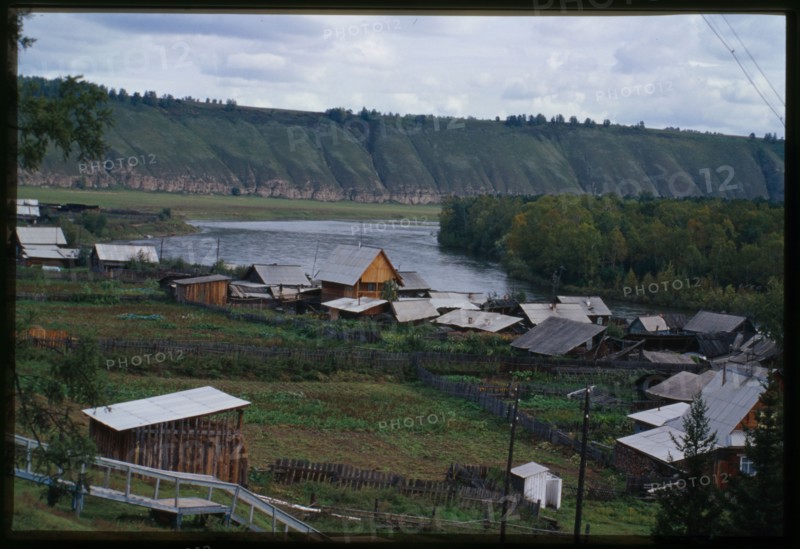 Log houses, with Belaia River in background, Bel'sk, Russia; 2000