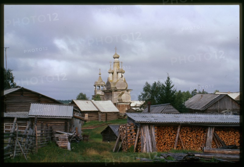 Church of the Hodigitria Icon of the Virgin (1763), southeast panorama with village houses, Kimzha, Russia; 2000