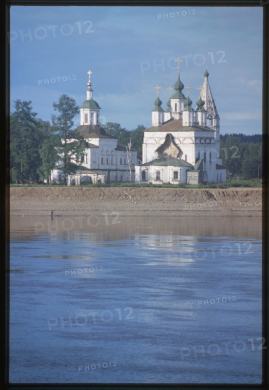 Church of St. Dmitrii (1700-09), and Church of St. Sergius Radonezh (1739-47), at Dymkova Sloboda, east panorama with Sukhona River, Velikii Ustiug, Russia 1998.