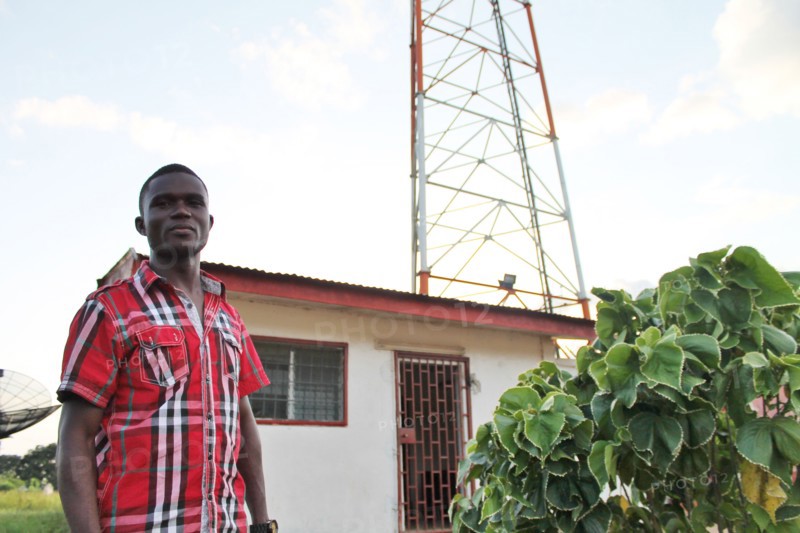 A local radio host stands outside radio station KR 94.5 as it is known, which gives the people of Ganta, Liberia and the surrounding areas plenty of talk radio, especially politics, culture, and the weekend's football results ca. 11 September 2013