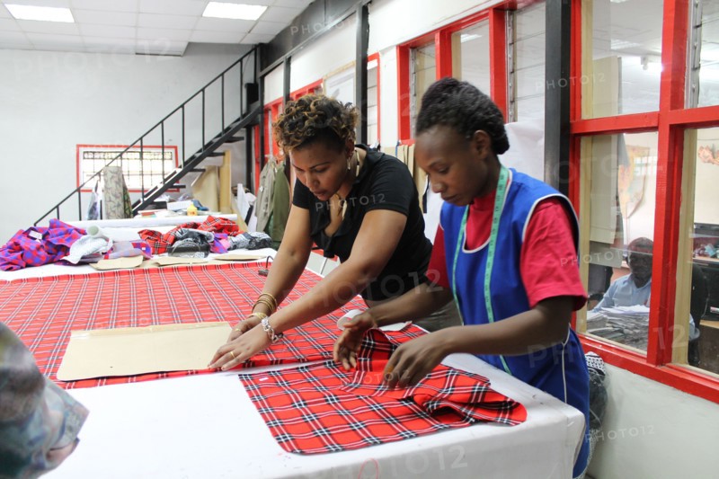 Woman working on Masai fabrics which are hand cut in preparation for custom made Doreen Mashika handbags. Each of these products are designed, manufactured, and produced by Africans, possibly in Kenya or Tanzania ca. 5 March 2014