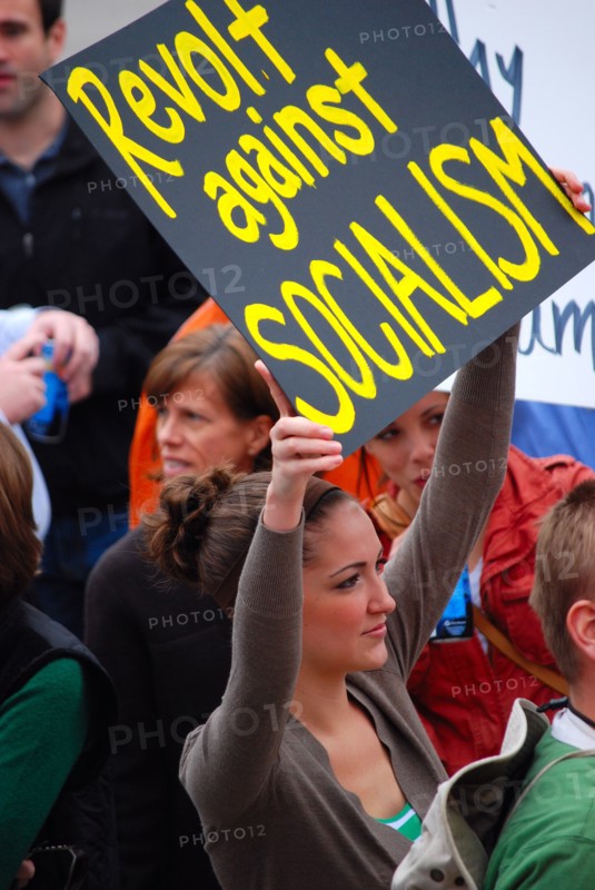 Attendees holding signs at a Tea Party rally in Dallas, TX (one of the first in the United States on Feb. 26 2009)