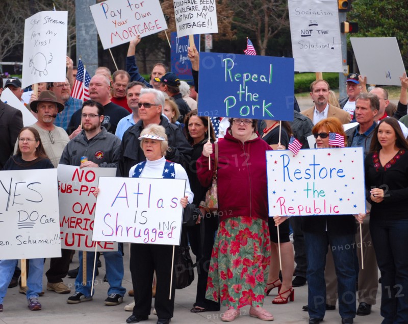 Attendees holding signs at a Tea Party rally in Dallas, TX (one of the first in the United States on Feb. 26 2009)