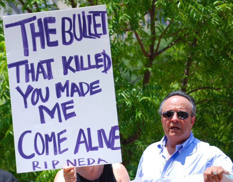 Iranians in Texas taking part in a Freedom for Iran / Green Revolution rally at Dallas City Hall plaza in downtown Dallas, TX; protest signs ca. June 2009