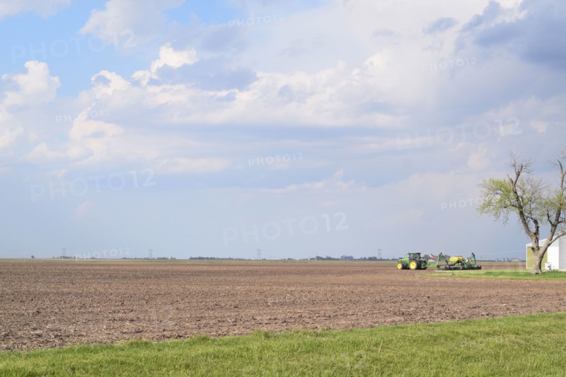 John Deere tractor in a field with no crops in eastern Illinois