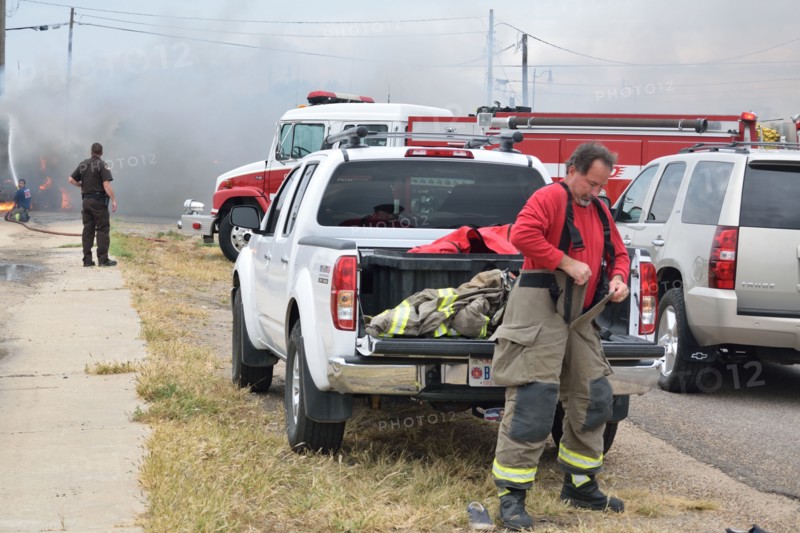 Firefighters on the scene of a truck fire, this fireman prepares to help, in Guymon, Oklahoma