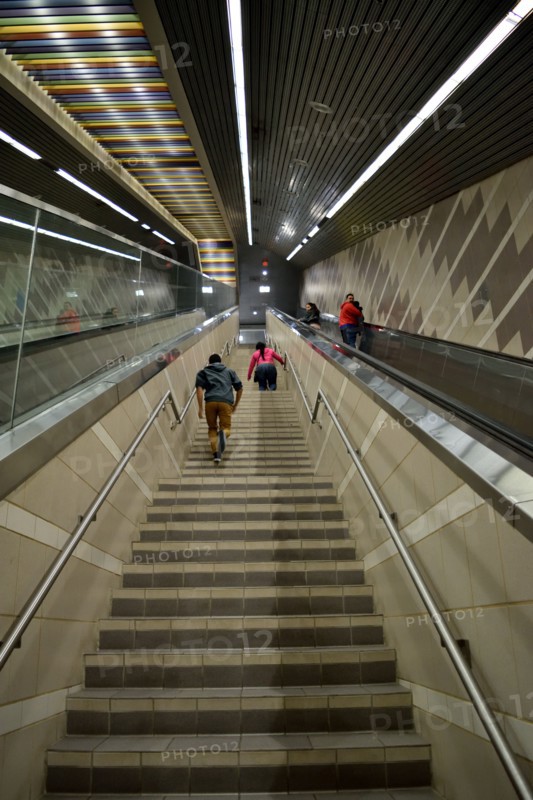 Passengers of a DART subway train climb the stairs of the Uptown station in Dallas, TX