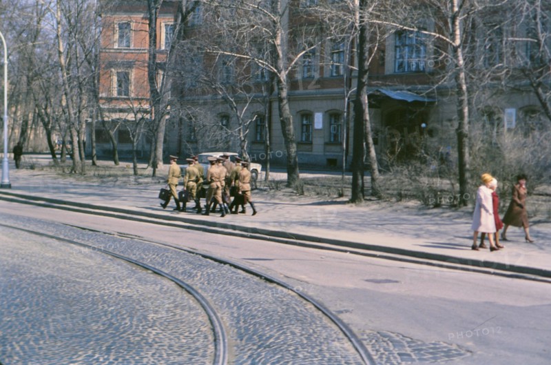 A group of Soviet soldiers carrying satchels and briefcases