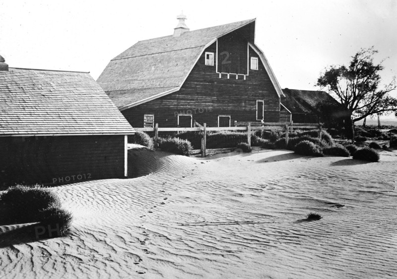 Barn on a farm with sand drifts during the 1930s