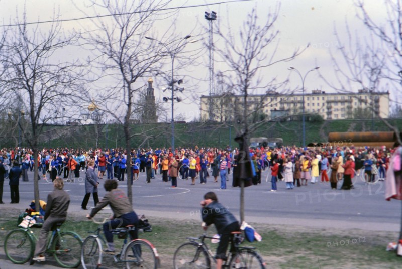 Bicyclists watching a parade of people in Moscow ca. May 1978