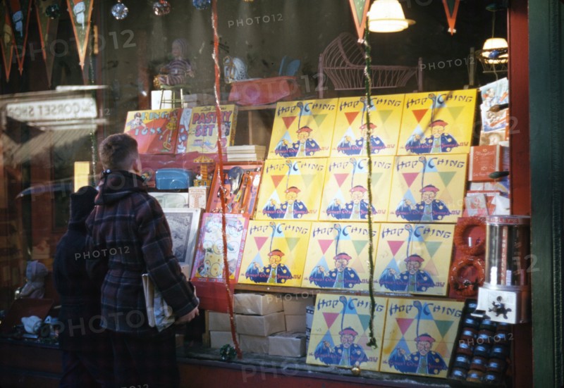 Boy looking at store window display of toys ca 1941