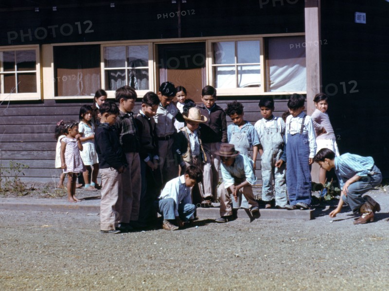 Boys playing marbles