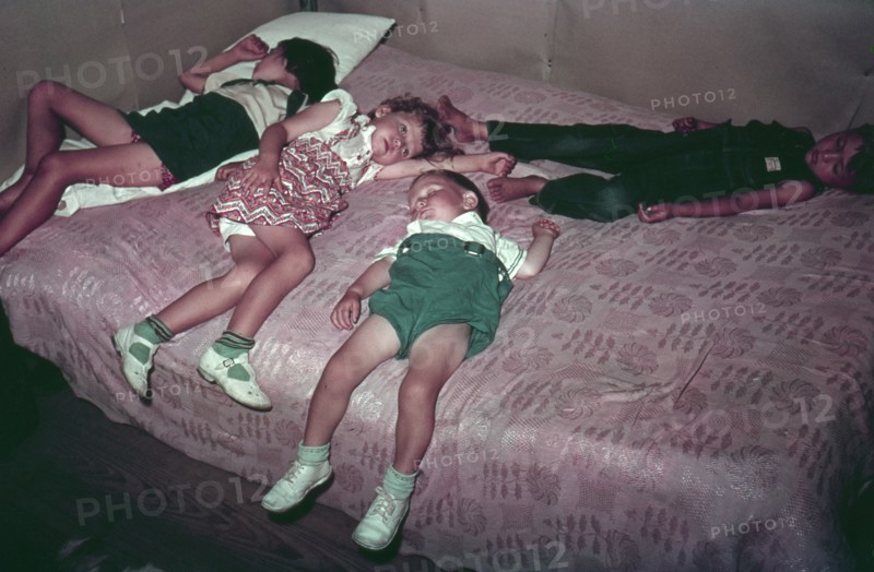 Children asleep on bed during square dance
