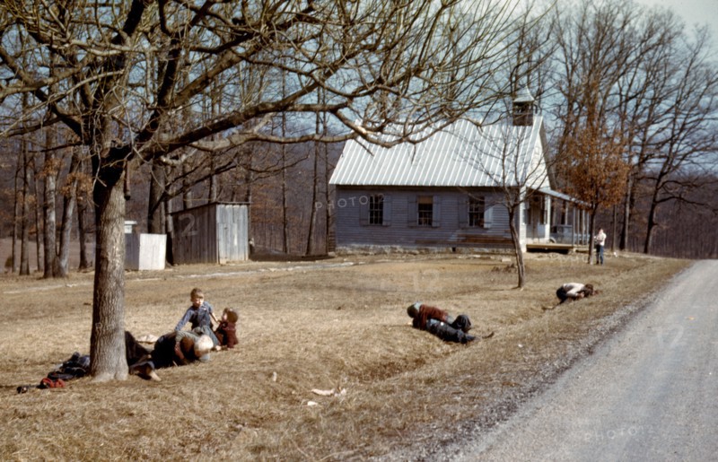 Children playing by road near school house