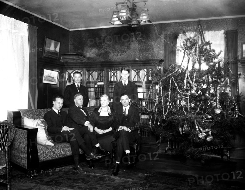 Family photo next to a Christmas tree ca. 1919