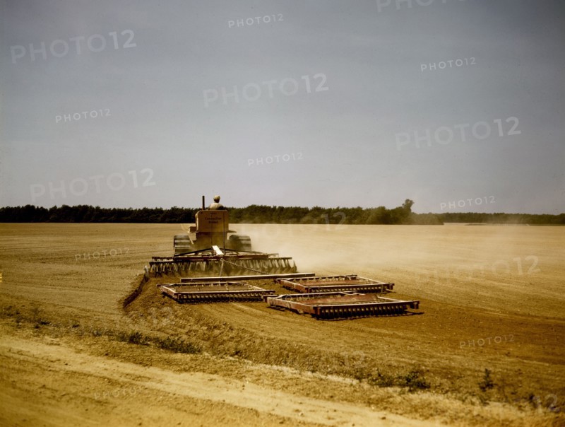Harrowing a field with a diesel tractor