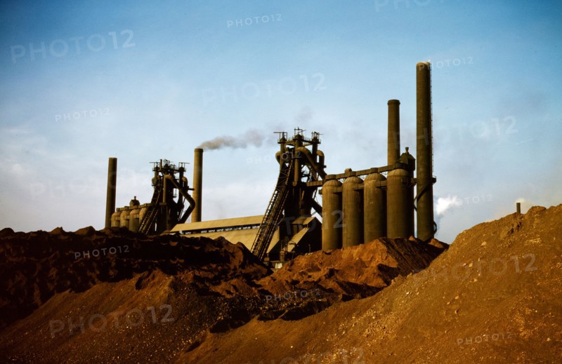 Iron ore piles and blast furnaces