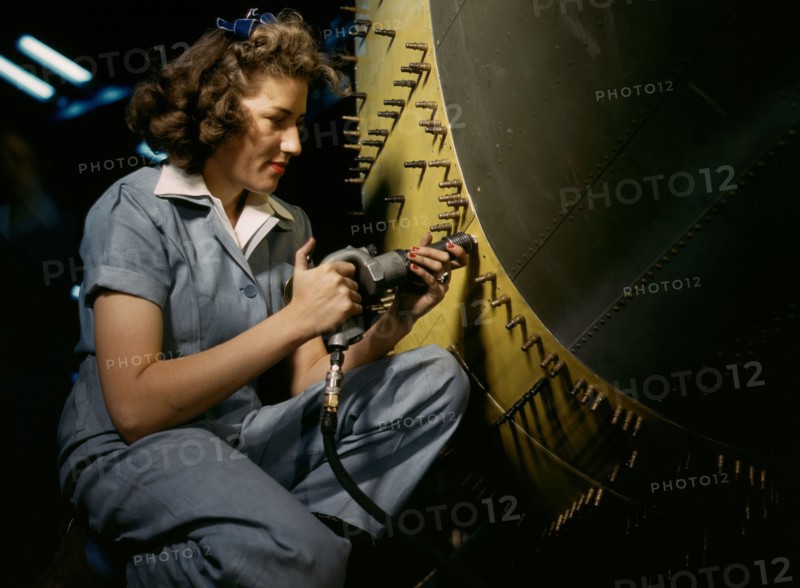 Riveter at work on Consolidated bomber