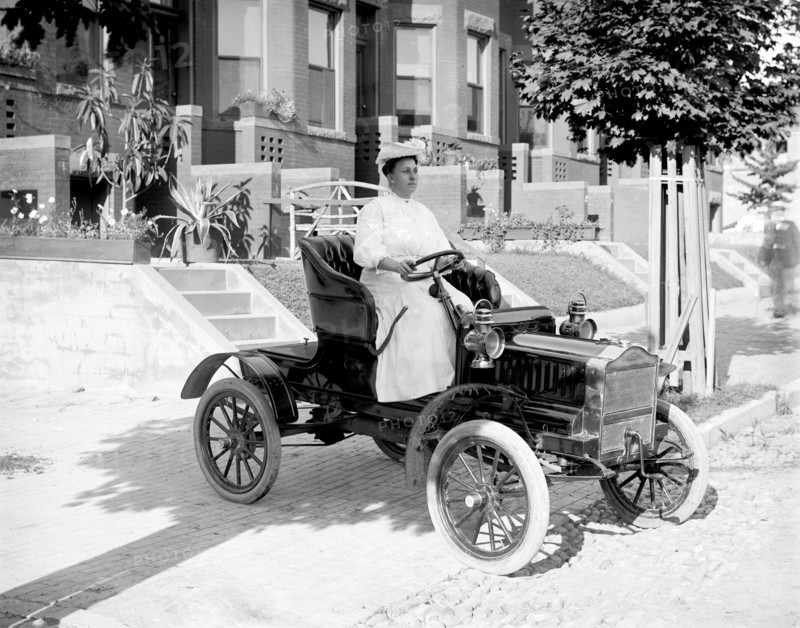 Woman driving an automobile in early 1900s