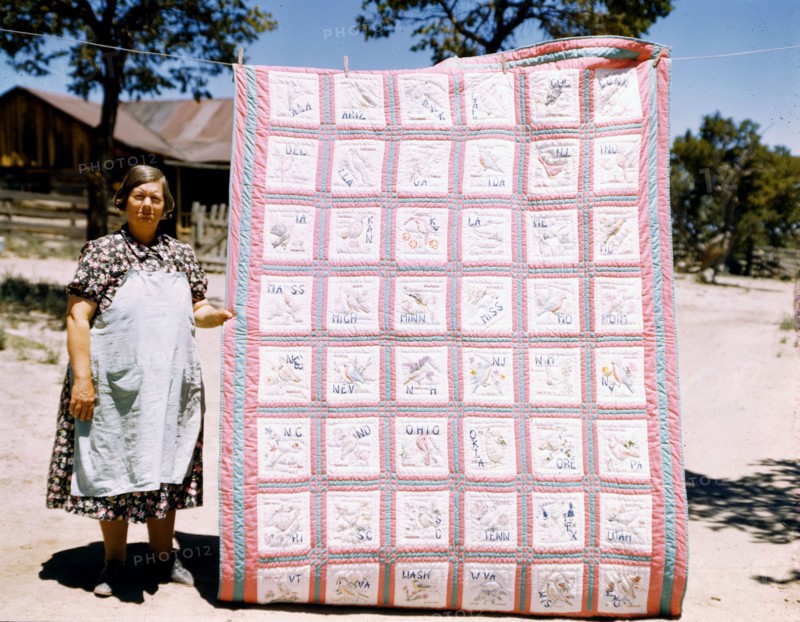 Woman quilter with state quilt which she made