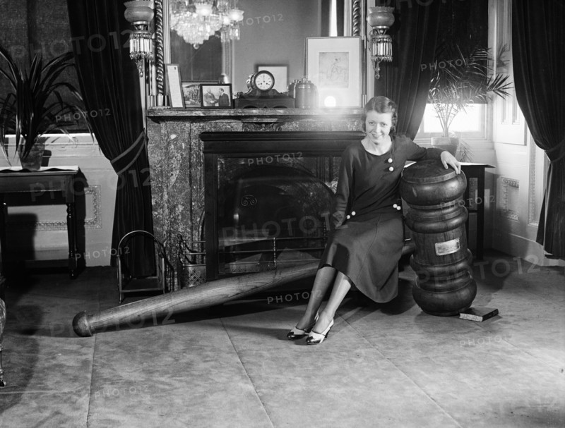 Woman seated on giant gavel ca. 1932