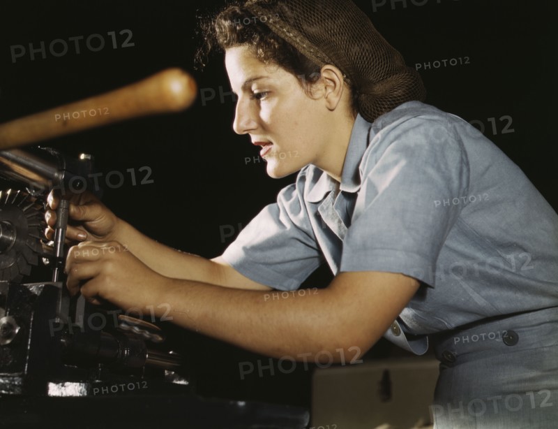 Woman working on transport parts in the hand mill