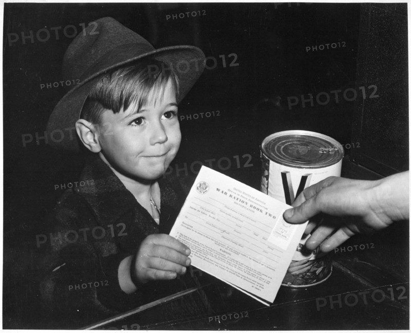 Young school boy uses War Ration Book