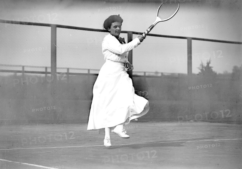 Miss E. Little playing tennis
