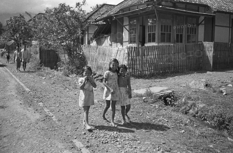 Three girls walk on the street (Gadog?); Date November 15, 1947 Location Indonesia, Dutch East Indies