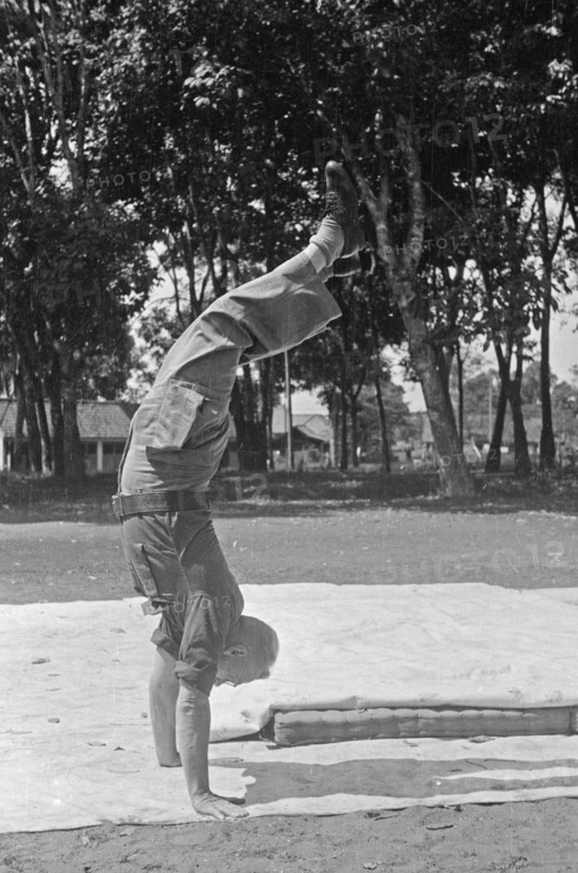 Dutch serviceman does handstand; Date June 1947; Location Indonesia, Dutch East Indies