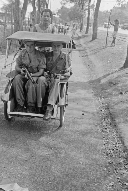 Two armed Dutch soldiers in a Bedjak in Batavia (Jakarta) Indonesia ca. 1947