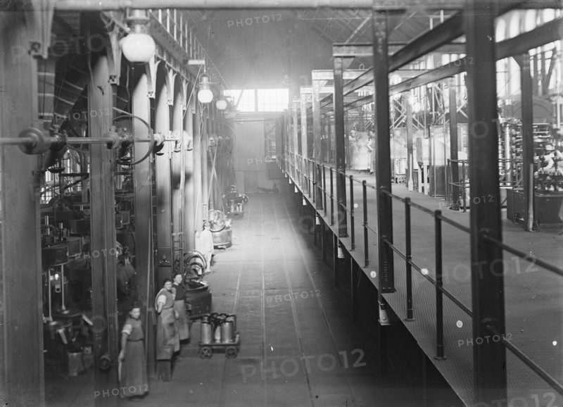 Workers pose in the press where the pure cocoa components are separated from the cocoa fats; Date 1910; Location Noord-Holland, Weesp