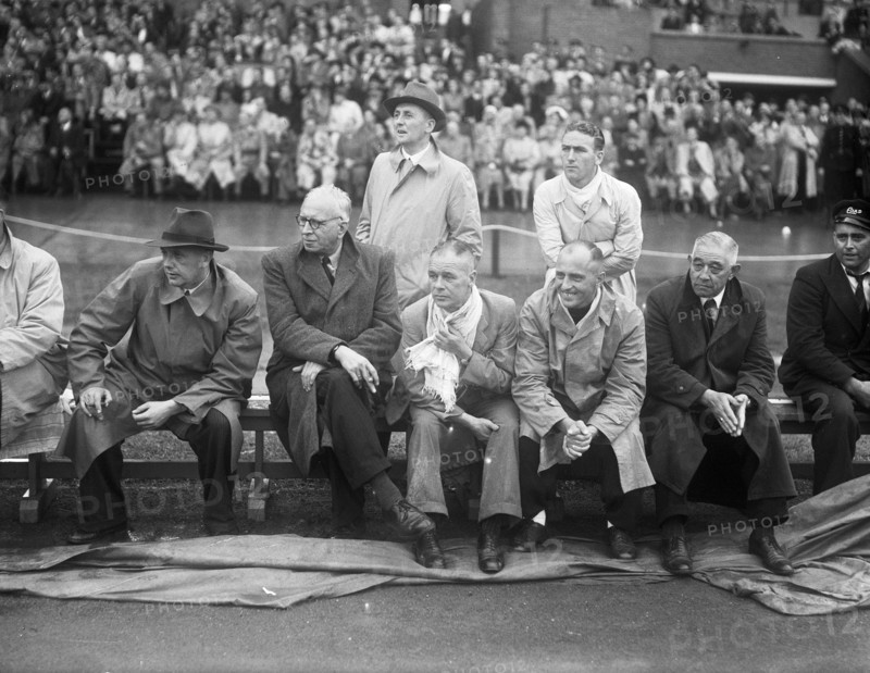 September 21, 1947 - Men on sidelines watching soccer match between Switzerland and Holland (possibly coaches)