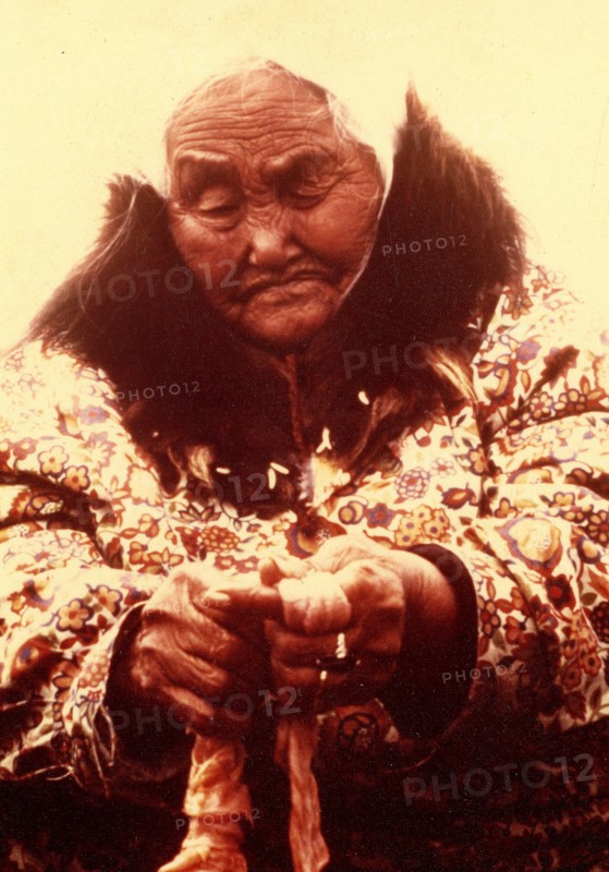 Early 1970s - Elderly Eskimo woman trimming seal intestines