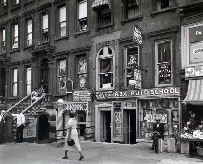 Woman walking in Harlem New York 422-424 Lenox Avenue, Manhattan ca. 1938