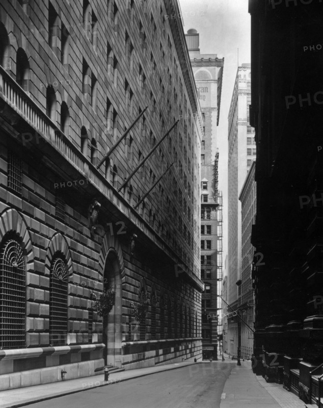 1930s New York City - Massive facade of Federal Reserve building fills left side, looking down Maiden Lane ca. 1936