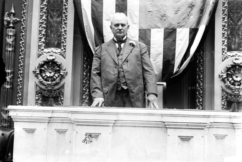 Photo shows Speaker of the House James Beauchamp 'Champ' Clark standing at the rostrum in the House of Representatives chamber, United States Capitol ca. 1911